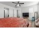 Bright bedroom featuring neutral walls and an inviting bed with seating and a TV at 7064 W Lincoln St, Peoria, AZ 85345