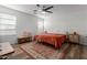 Comfortable bedroom featuring wood-look floors, a ceiling fan and a bright window at 7064 W Lincoln St, Peoria, AZ 85345