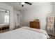 Bright bedroom with a ceiling fan, dresser, and a closet featuring mirrored doors at 7064 W Lincoln St, Peoria, AZ 85345