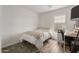 Well-lit bedroom with a large window and a desk area for work or study at 7064 W Lincoln St, Peoria, AZ 85345