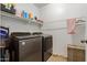 Organized laundry room with modern washer and dryer, shelving and storage solutions at 7064 W Lincoln St, Peoria, AZ 85345