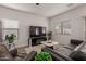 Modern living room with wood floors, leather sofa, contemporary decor, and large-screen television at 7064 W Lincoln St, Peoria, AZ 85345