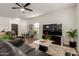 Modern living room with wood floors, leather sofa, contemporary decor, and large-screen television at 7064 W Lincoln St, Peoria, AZ 85345