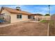 Expansive backyard featuring a partially landscaped area with patio, and a view of the home's exterior at 7114 W Oregon Ave, Glendale, AZ 85303