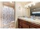 Cozy bathroom features stylish vanity and tiled shower with curtain at 7114 W Oregon Ave, Glendale, AZ 85303