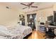 This bedroom features a ceiling fan, closet and desk at 7114 W Oregon Ave, Glendale, AZ 85303