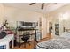 Bedroom featuring a study area with multiple monitors and neutral wall color, plus hardwood floors at 7114 W Oregon Ave, Glendale, AZ 85303