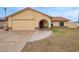 Charming single-story home featuring a tan exterior, an arched entryway, and a two-car garage at 7114 W Oregon Ave, Glendale, AZ 85303