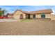 Single-story home featuring a tan exterior, a two-car garage, and manicured front yard at 7114 W Oregon Ave, Glendale, AZ 85303