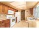 This kitchen features white appliances and wood cabinets at 7114 W Oregon Ave, Glendale, AZ 85303