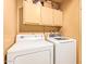 Laundry room featuring a dryer and washing machine, plus cabinets at 7114 W Oregon Ave, Glendale, AZ 85303