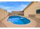 Backyard view showcasing a sparkling blue in-ground pool and the home's exterior at 7114 W Oregon Ave, Glendale, AZ 85303