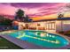 Inviting backyard with a sparkling pool, patio area, outdoor kitchen, and Arizona flag feature wall at 7308 E Diamond St, Scottsdale, AZ 85257