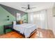Comfortable bedroom showcasing a modern ceiling fan, hardwood floors, and contemporary wall decor at 7308 E Diamond St, Scottsdale, AZ 85257