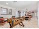Spacious game room featuring a foosball table, bar area, dining space and access to an outdoor seating area at 7308 E Diamond St, Scottsdale, AZ 85257
