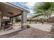 Inviting back patio featuring ceiling fans and a desert landscaped backyard at 7308 S 29Th Ln, Phoenix, AZ 85041