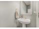 Fresh powder room showcases a pedestal sink, decorative mirror, and neutral paint at 7308 S 29Th Ln, Phoenix, AZ 85041