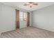 Blue bedroom featuring carpet, curtained window, and neutral trim at 7308 S 29Th Ln, Phoenix, AZ 85041