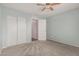 Blue bedroom with sliding closet doors and a neutral door leading to other rooms at 7308 S 29Th Ln, Phoenix, AZ 85041