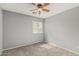 Neutral bedroom showcasing a ceiling fan, window for natural light, and plush carpet at 7308 S 29Th Ln, Phoenix, AZ 85041
