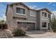 Two-story home featuring a two-car garage, landscaped front yard with desert rock and drought resistant plants at 7308 S 29Th Ln, Phoenix, AZ 85041