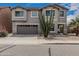 Two-story home with a two-car garage, landscaped front yard, and a decorative Southwestern desert plants at 7308 S 29Th Ln, Phoenix, AZ 85041