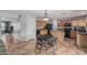 Spacious kitchen features a center island, wood cabinetry, stainless steel appliances, and tiled flooring at 7308 S 29Th Ln, Phoenix, AZ 85041