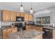 Charming kitchen featuring granite countertops, an island, and updated appliances at 7308 S 29Th Ln, Phoenix, AZ 85041