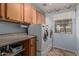 Convenient laundry room featuring front-load washer and dryer with cabinets and counter space at 7308 S 29Th Ln, Phoenix, AZ 85041