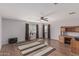 Spacious living room features a ceiling fan, hardwood floors, and a functional desk area at 7308 S 29Th Ln, Phoenix, AZ 85041