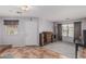 Open living room with ceramic tile, grey walls, with front door view and access to other rooms at 7308 S 29Th Ln, Phoenix, AZ 85041