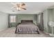 Comfortable main bedroom features a ceiling fan, carpet, and neutral paint at 7308 S 29Th Ln, Phoenix, AZ 85041