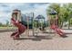 Community playground in the park with slides and climbing structures, encouraging outdoor play and social interaction at 7308 S 29Th Ln, Phoenix, AZ 85041