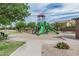 Inviting community playground with lush trees and benches at 7308 S 29Th Ln, Phoenix, AZ 85041