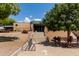 Exterior of community aquatic center with green trees, manicured gardens, benches, bike rack, and open space at 8314 E Vista Dr, Scottsdale, AZ 85250