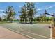 Outdoor basketball court with recreational space, mature trees and lake in background, under a bright blue sky at 8314 E Vista Dr, Scottsdale, AZ 85250