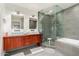 Modern bathroom featuring dual sinks, glass shower and soaking tub at 8314 E Vista Dr, Scottsdale, AZ 85250