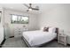 Bright bedroom with large window, ceiling fan, and a modern white dresser at 8314 E Vista Dr, Scottsdale, AZ 85250