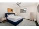 Stylish bedroom with a blue padded headboard and a painting on the wall at 8314 E Vista Dr, Scottsdale, AZ 85250