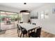 Dining room features modern chandelier, a marble table with seating for six, and sliding door to an outdoor patio at 8314 E Vista Dr, Scottsdale, AZ 85250