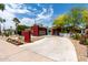 Concrete driveway leads to a modern home with vibrant landscaping and a two-car garage at 8314 E Vista Dr, Scottsdale, AZ 85250