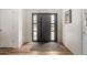Modern entryway features a sleek door with sidelights, hardwood floors, and neutral paint at 8314 E Vista Dr, Scottsdale, AZ 85250