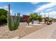 Landscaped front yard featuring cacti, gravel, and a modern home exterior with unique architectural elements at 8314 E Vista Dr, Scottsdale, AZ 85250