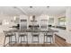 Spacious kitchen island with bar stool seating, stainless steel appliances, and stylish pendant lighting overhead at 8314 E Vista Dr, Scottsdale, AZ 85250