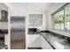 Modern kitchen features stainless steel appliances, granite countertops, and ample natural light from the adjacent window at 8314 E Vista Dr, Scottsdale, AZ 85250