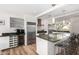 Modern kitchen featuring stainless steel appliances, granite countertops and a wine fridge at 8314 E Vista Dr, Scottsdale, AZ 85250