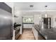 Updated kitchen featuring granite countertops, stainless steel appliances, a large island with sink, and wood laminate floors at 8314 E Vista Dr, Scottsdale, AZ 85250