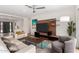 Well-lit living area with modern entertainment center, comfortable seating, and a view towards the home's entrance at 8314 E Vista Dr, Scottsdale, AZ 85250