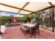 Charming outdoor patio features a dining area, lush greenery, and comfortable lounge seating at 8314 E Vista Dr, Scottsdale, AZ 85250
