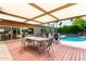 Covered patio with outdoor dining set and lounge area, perfect for entertaining and relaxing near the pool at 8314 E Vista Dr, Scottsdale, AZ 85250